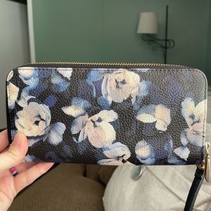 Blue, and black wristlet with white/gray flowers. New without tags. Never used.